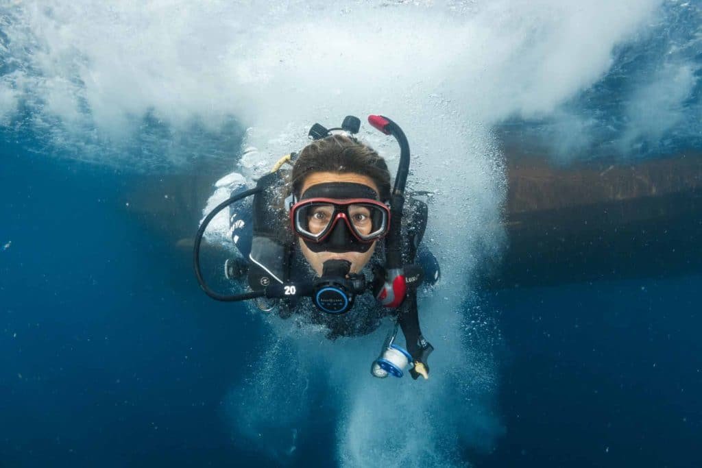 diver-under-water-air-bubbles