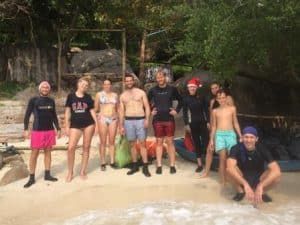 group cleaning beach