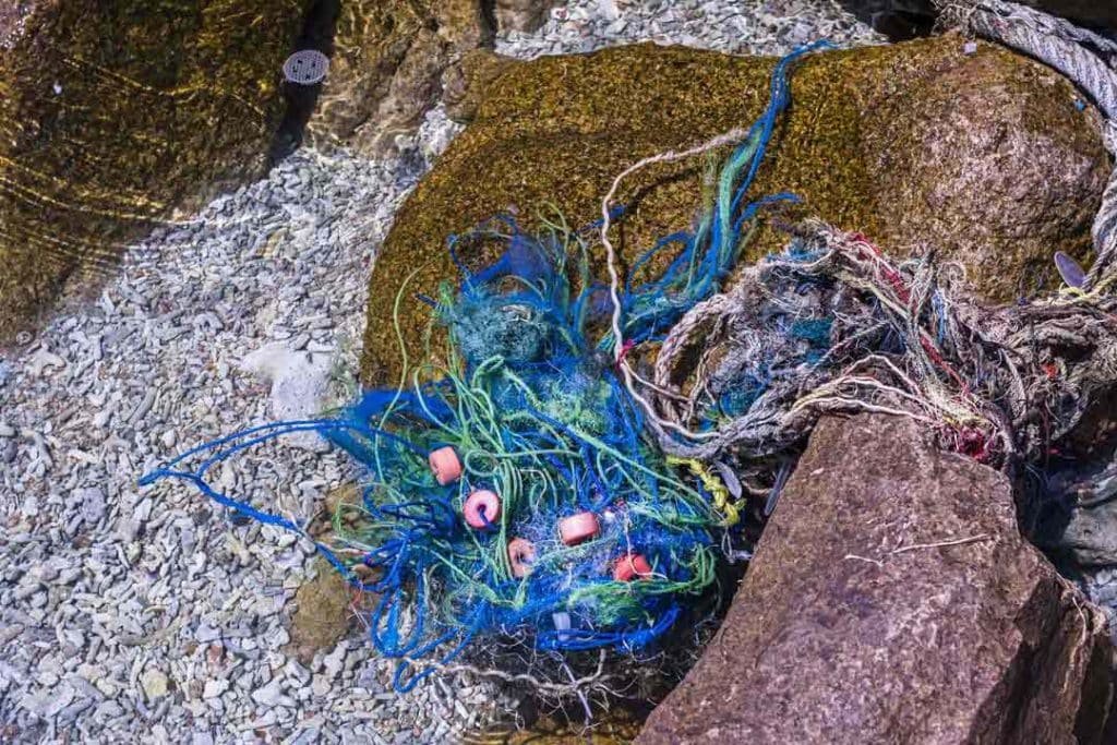 More ropes and nets washed up on the rocks